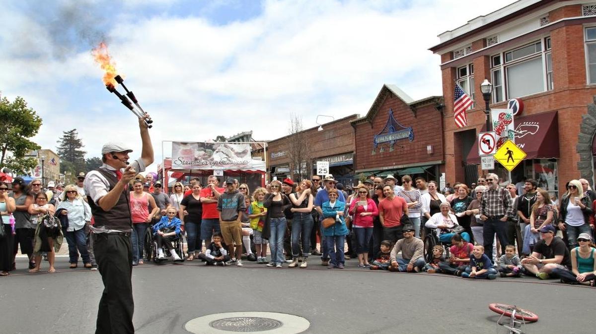 A fire-wielding juggler entertains the crowd at the Arroyo Grande Strawberry Festival in 2015. The festival returns to the Village of Arroyo Grande this Memorial Day weekend.
