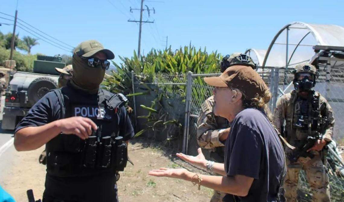 A crowd confronts federal agents conducting an immigration enforcement operation at a Carpinteria cannabis farm Thursday, July 10, 2025. Ten workers were reportedly detained.