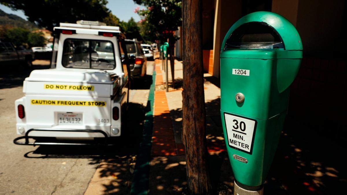 A San Luis Obispo city parking vehicle is seen near a 30 minute meter in downtown. The city of San Luis Obispo’s parking rates increase starting in July.