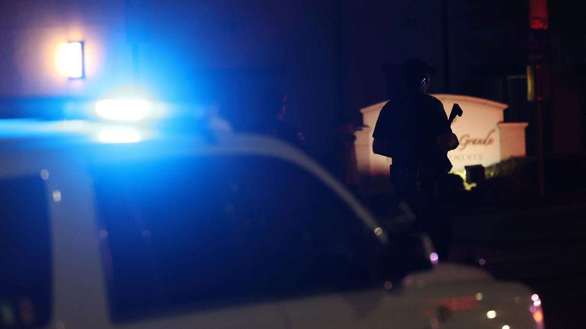 An officer with a rifle stands outside the Cortina D’Arroyo Grande Apartments at 241 N. Courtland St. in Arroyo Grande after one person was killed in a shooting Wednesday afternoon, Jan. 31, 2024. The county SWAT team was negotiating with a suspect who had barricade himself inside his apartment, police said.