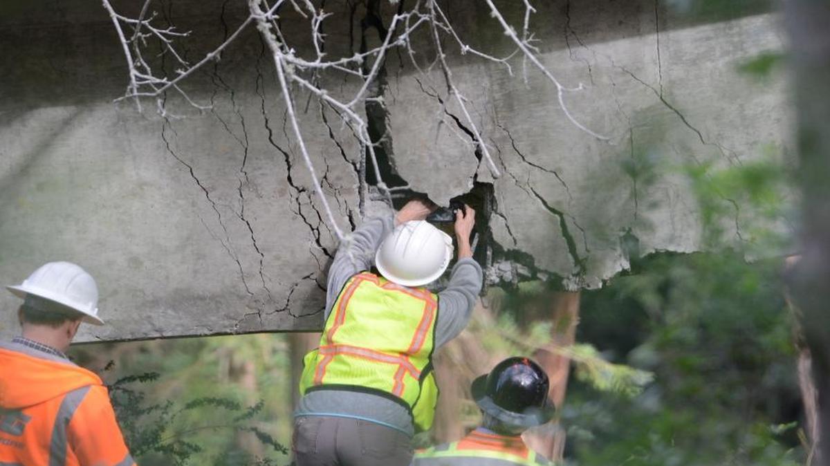 On Wednesday, Caltrans engineers evaluate a large crack on the Pfeiffer Canyon Bridge on Highway 1 in Big Sur. The bridge has crumbled beyond repair, blocking passage on the north-south Highway 1 route for up to a year.
