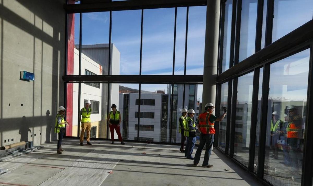 A living room is framed with windows at Cal Poly’s new community housing complex on Grand Avenue.