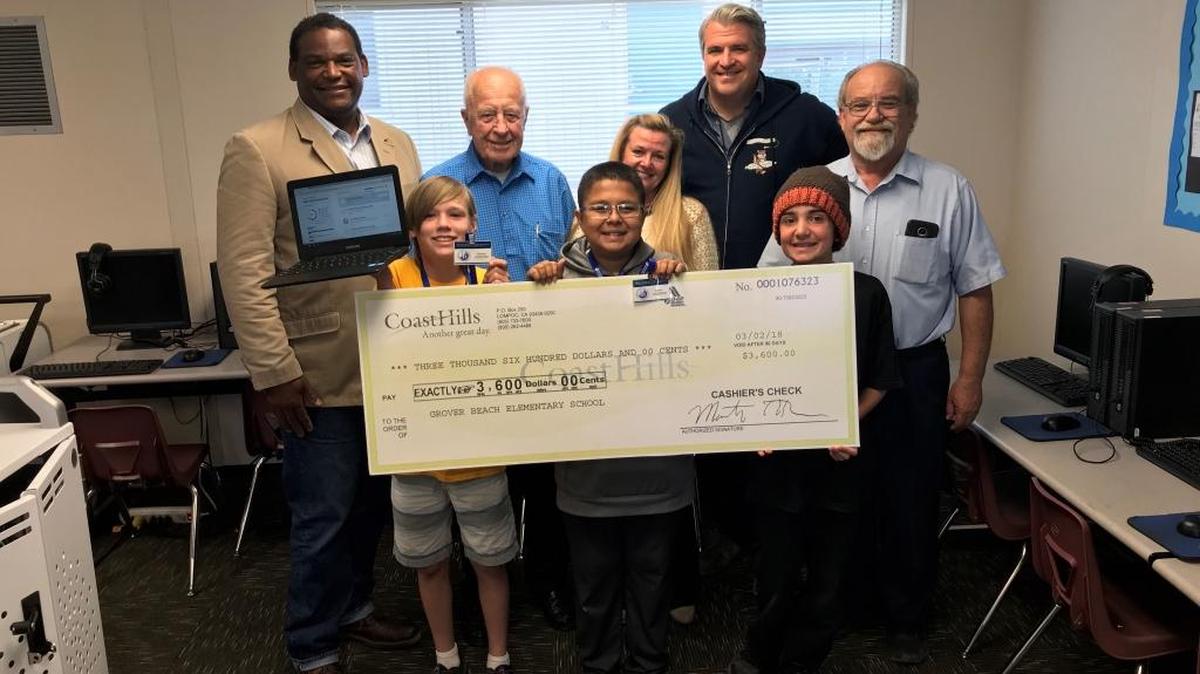 In the back row, Grover Beach Mayor John Shoals, Bill Nicolls of Grover Beach Community Foundation, Karen Bright of Grover Beach Community Foundation, Grover Beach Elementary Principal James Snyder and Dave Anderson of Grover Beach Community Foundation present a check for $3,600 to Grover Beach Elementary School for the purchase of 24 Google Chromebooks. In the front row, from left, are Spencer Murray, 11; Darrien Terrones, 12, and Dean Meade, 11, all in sixth grade at Grover Beach Elementary.