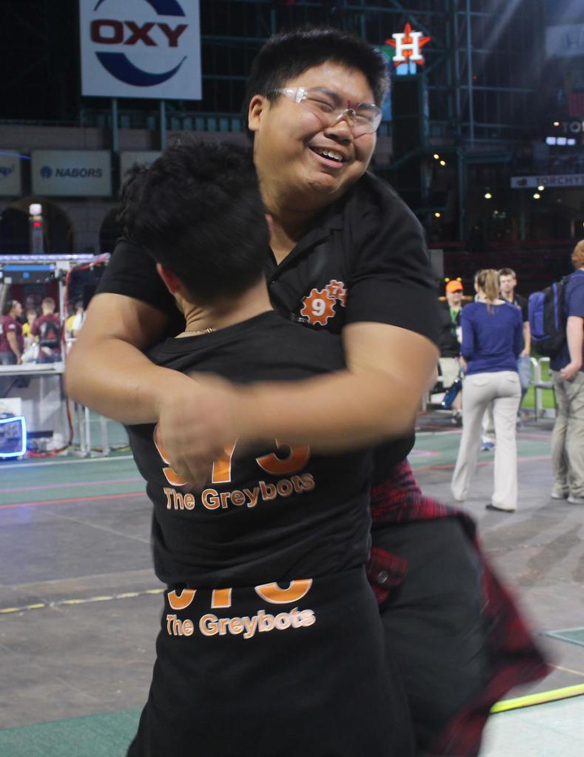 Mentor Alex Cherry lifts Kyle DeMatias while celebrating their win at the FIRST World Championship in Houston this past weekend.