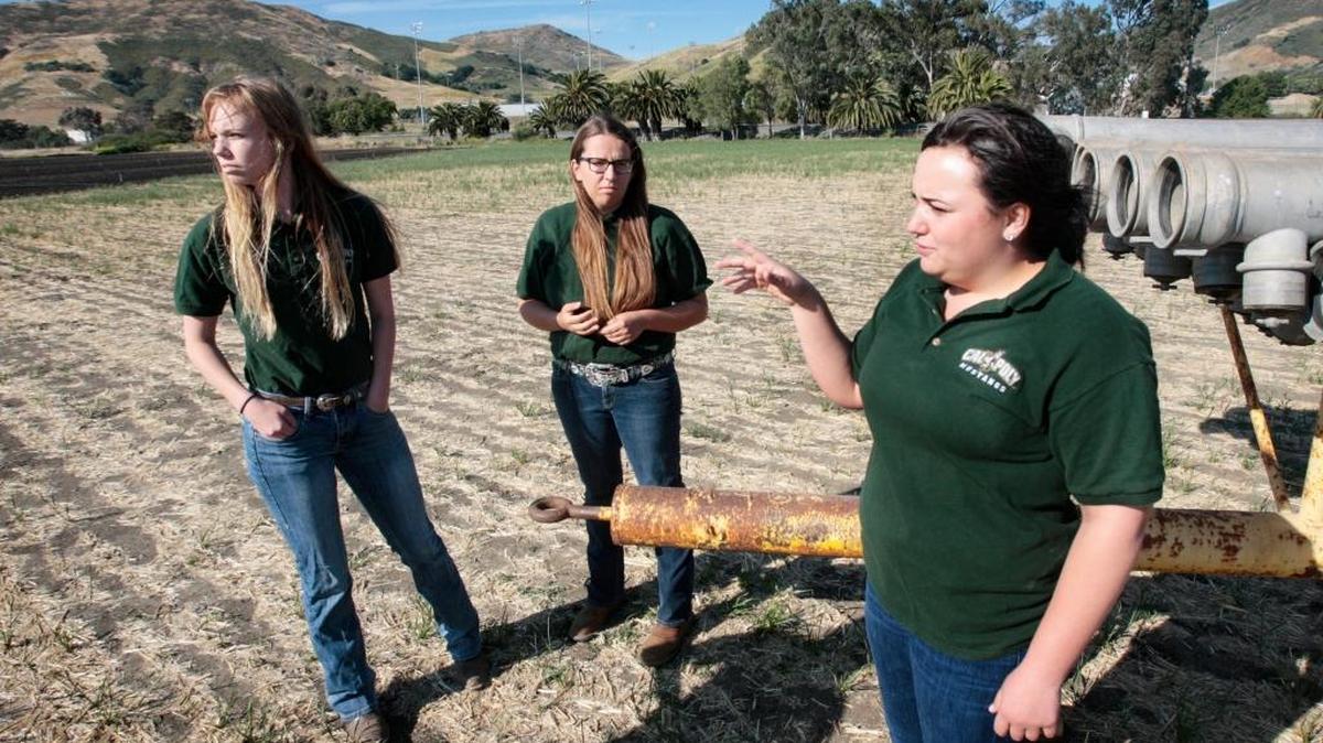 Cal Poly School of Agriculture, Food and Environmental Science students, from left, Amber LaSalle, Elizabeth Russell, Toni Silva, are not happy with long-term draft planning that could convert this ag field into athletic fields.