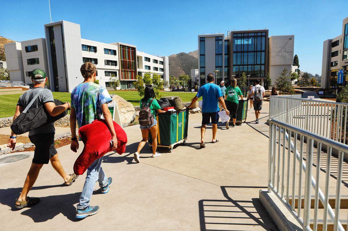 Cal Poly students and their parents move items into the university’s new $198 million yakʔitʸutʸu housing complex on Friday, September 14, 2018.