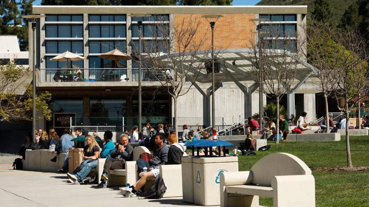 Cal Poly students sit outside at the University Union on campus in San Luis Obispo, California.