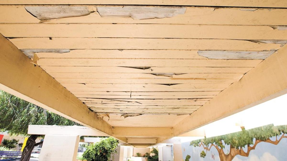 The peeling paint on the underside of this walkway overhang at Fairgrove Elementary in Grover Beach is one of the improvements needed at Lucia Mar schools.
