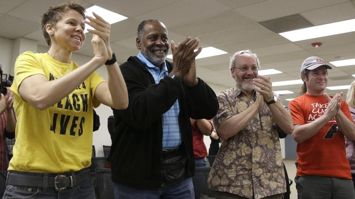 California Faculty Association members, Molly Talcott, left, Cecil Canton, second from left, Jonathan Karpf, third from left, and Mark Karplus, right, applaud after a news conference to discuss the tentative agreement between CSU facility members and the California State University system, Friday, April 8, 2016, in Sacramento. The CSU faculty union announced Tuesday that its members overwhelmingly approved a new contract that will raise salaries by more than 10 percent over the next two years.