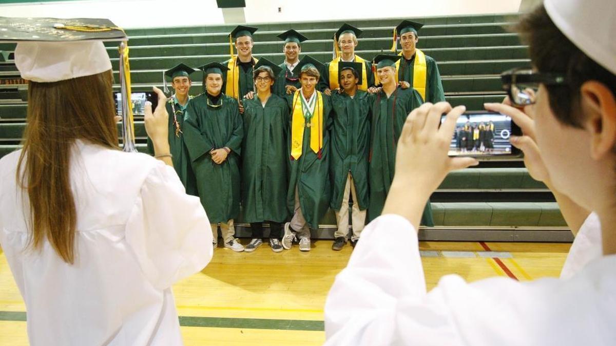 Templeton High School seniors pose for a photo with friends before the start of their graduation ceremony Tuesday.