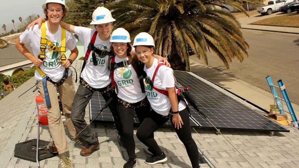 First-year Honors Program students, from left, Charlie Gibbons, a sophomore from Fountain Valley, Calif, who is majoring in environmental management and protections; Blaine Benham, a junior studying biology from San Diego; and mechanical engineering juniors Cayla Quinn of Walnut Creek, Calif., and Sophie Spencer of Phoenix work on a solar panel installation in Santa Maria. A team of six honors students (including those pictured) partnered with GRID Alternatives to create a solar energy jobs guidebook in support of their yearlong service project.