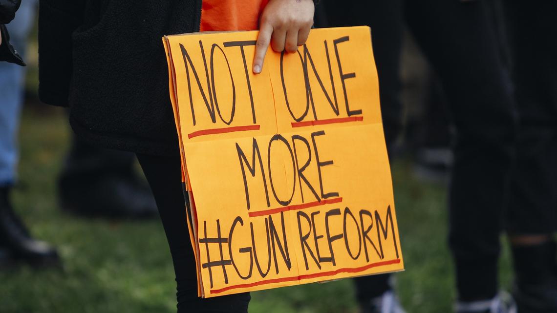 A student holds a sign at San Luis Obispo High School as part of the National Walkout for Gun Safety on March 14.