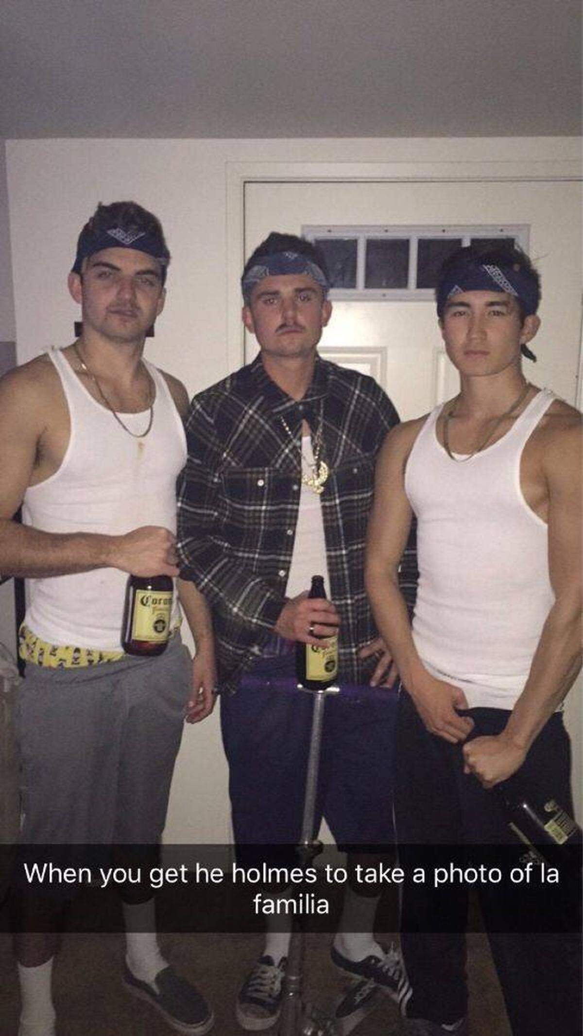 A photo shared on social media Tuesday, April 17, 2018, appears to show three Sigma Nu fraternity members dressed in bandanas, baggy pants, white ribbed tank tops, chains and a fake mustache.