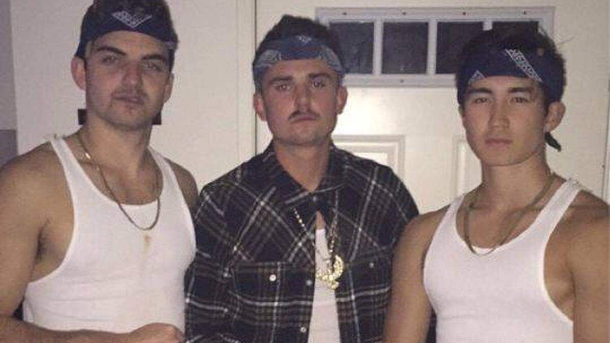 A photo shared on social media Tuesday, April 17, 2018, appears to show three Sigma Nu fraternity members dressed in bandanas, baggy pants, white ribbed tank tops, chains and a fake mustache.