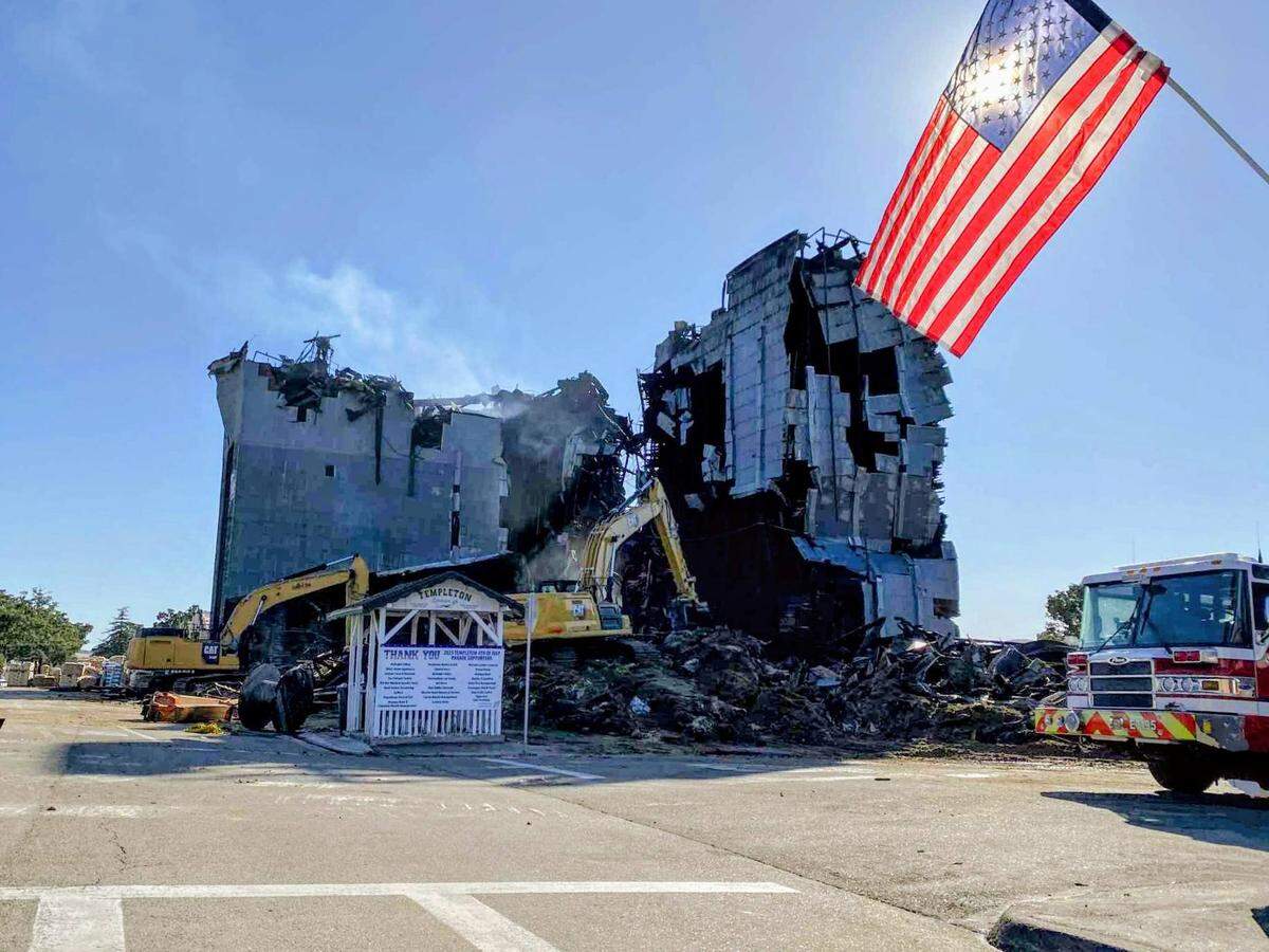 A demolition team brought down the southern portion of the burned-out Templeton Feed & Grain building on Monday, July, 7, 2025, after a fire gutted the historic granary on the Fourth of July.