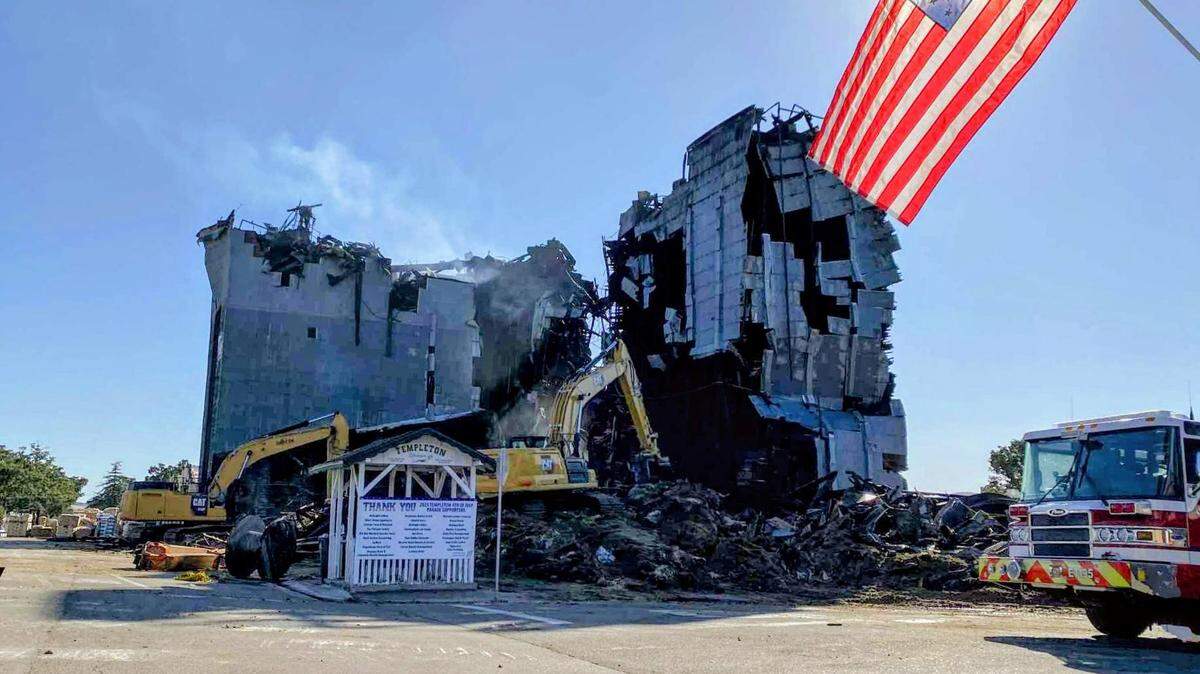 A demolition team brought down the southern portion of the burned-out Templeton Feed & Grain building on Monday, July, 7, 2025, after a fire gutted the historic granary on the Fourth of July.