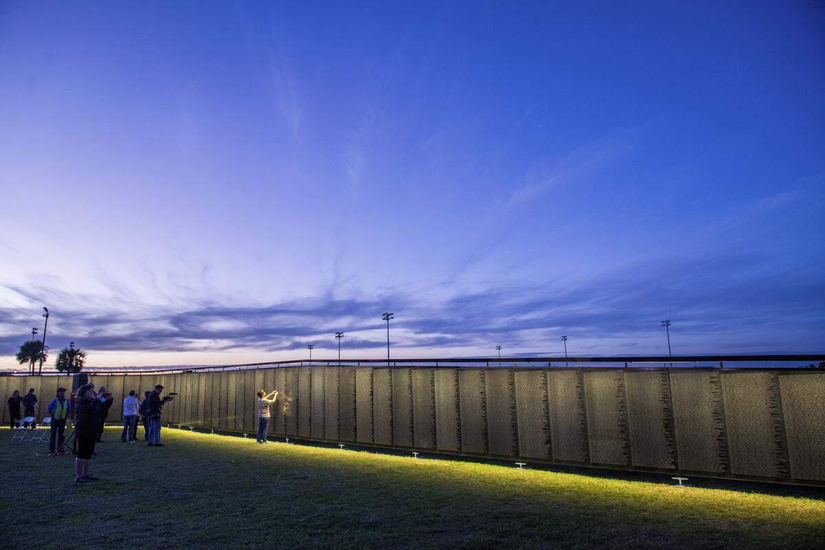 SLO County residents visit The Wall That Heals while the sun sets.