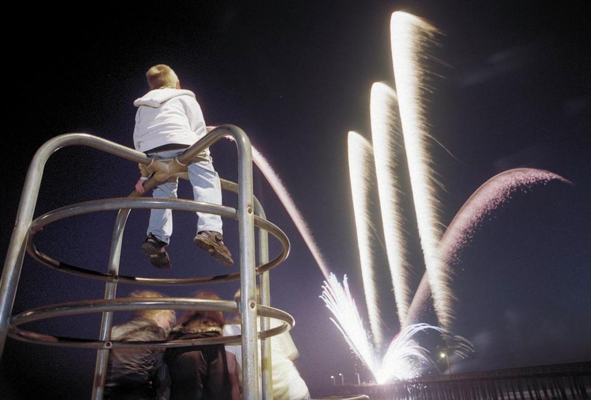 Harley Faria, 7, of Paso Robles watches the fireworks from the top of the monkey bars in Cayucos. It’s one of a few Central Coast cities that offer free Fourth of July fireworks shows.