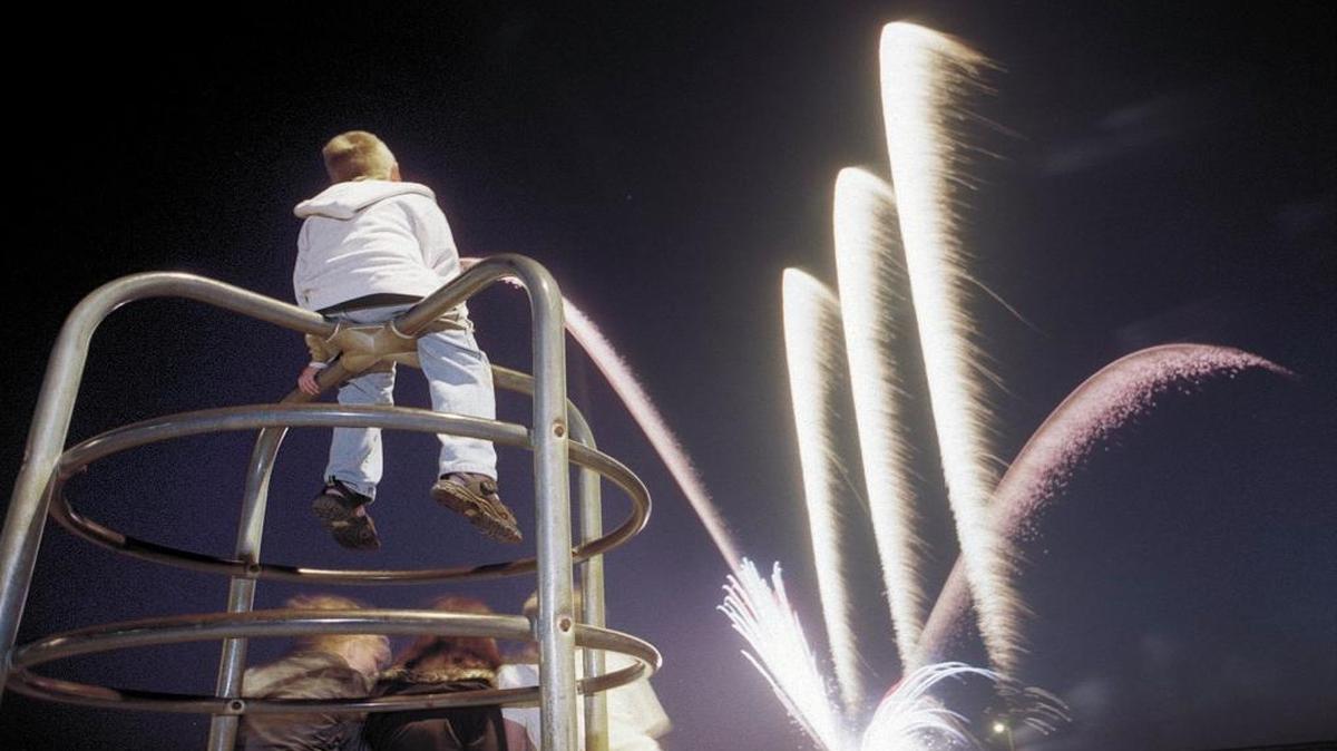 Harley Faria, 7, of Paso Robles watches the fireworks from the top of the monkey bars in Cayucos. It’s one of a few Central Coast cities that offer free Fourth of July fireworks shows.
