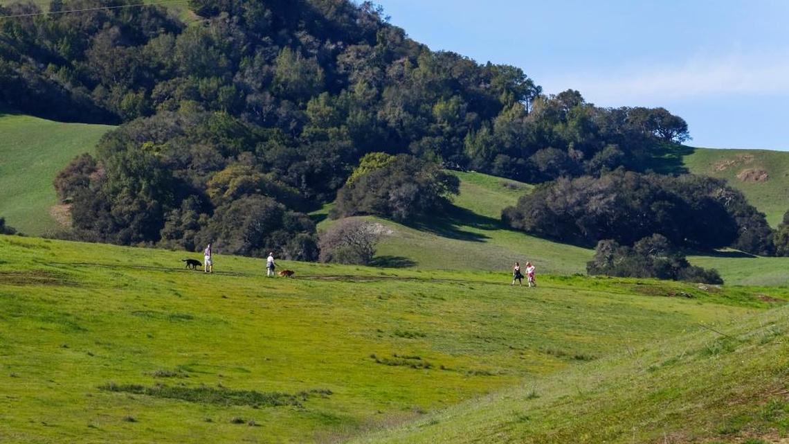 Hikers stroll amongst the green hills of the Johnson Ranch Open Space in San Luis Obispo in 2018.