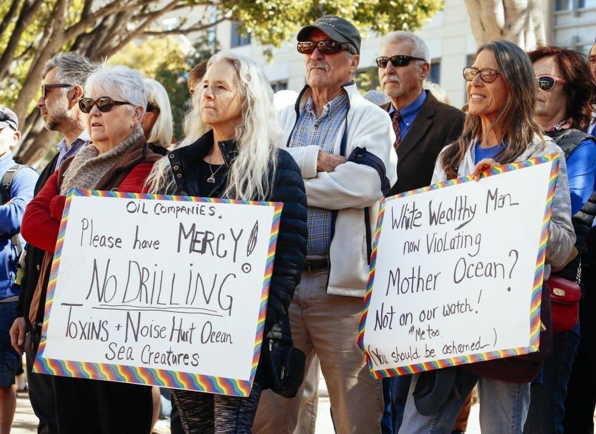 Elly Cannon, left, and Gail McBride holds signs voicing their opposition to offshore oil drilling during a rally Wednesday in front of the county courthouse in San Luis Obispo.