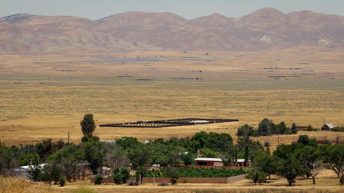 Fenced marijuana grows dot the landscape in California Valley. The county is considering whether to ban cannabis farms in the area.