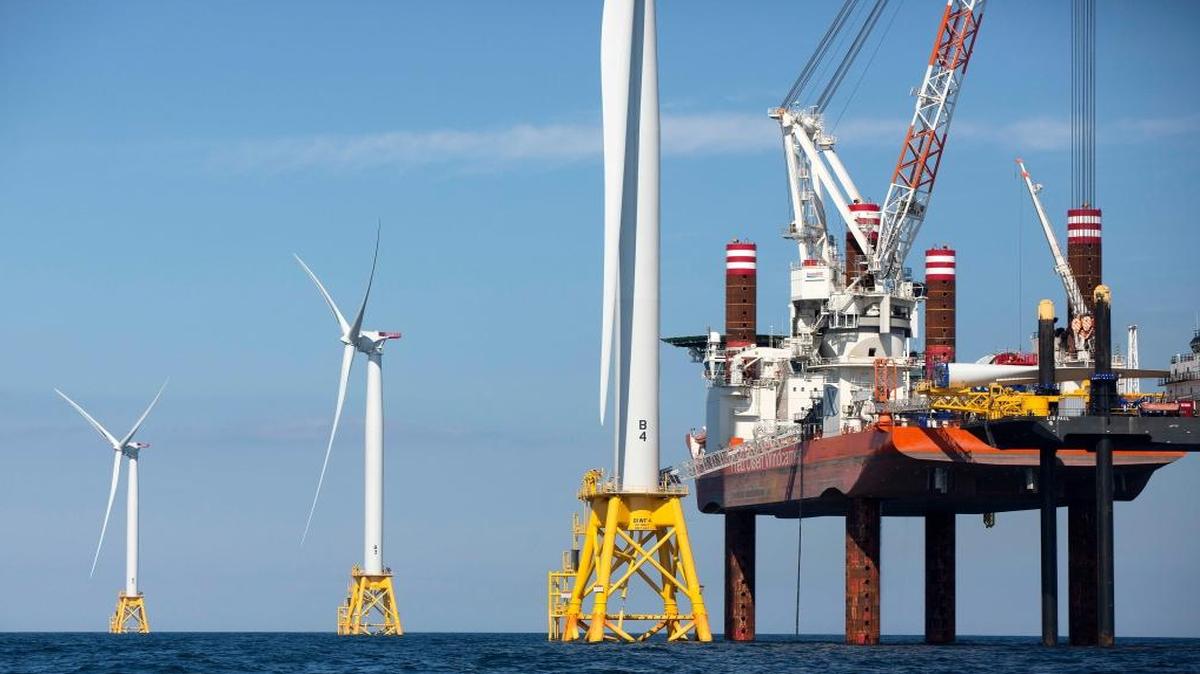 A lift boat, right, that serves as a work platform, assembles a wind turbine off Block Island, R.I., on Aug. 15, 2016.