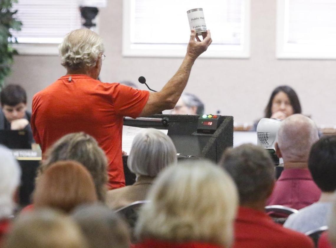 Nipomo Mesa resident Laurance Schinderman holds up a visual metaphor, a can to kick down the road, during the Coastal Commission’s meeting to consider State Parks’ dust control efforts at Oceano Dunes State Vehicular Recreation Area.