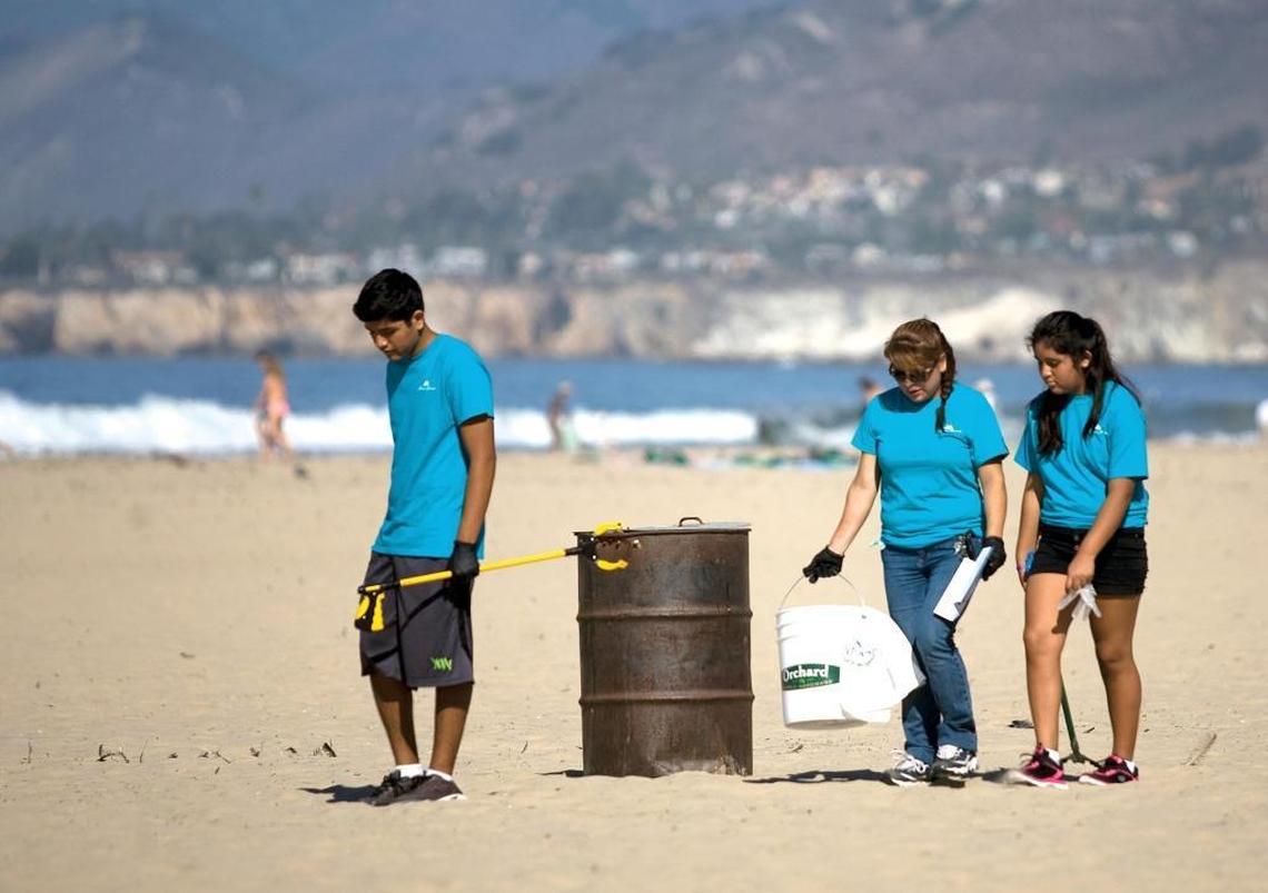 Grover Beach resident, Monica Perez (center), brought her children Victor (left) and Dania to the Pismo Beach Pier area to clean up trash in 2015.
