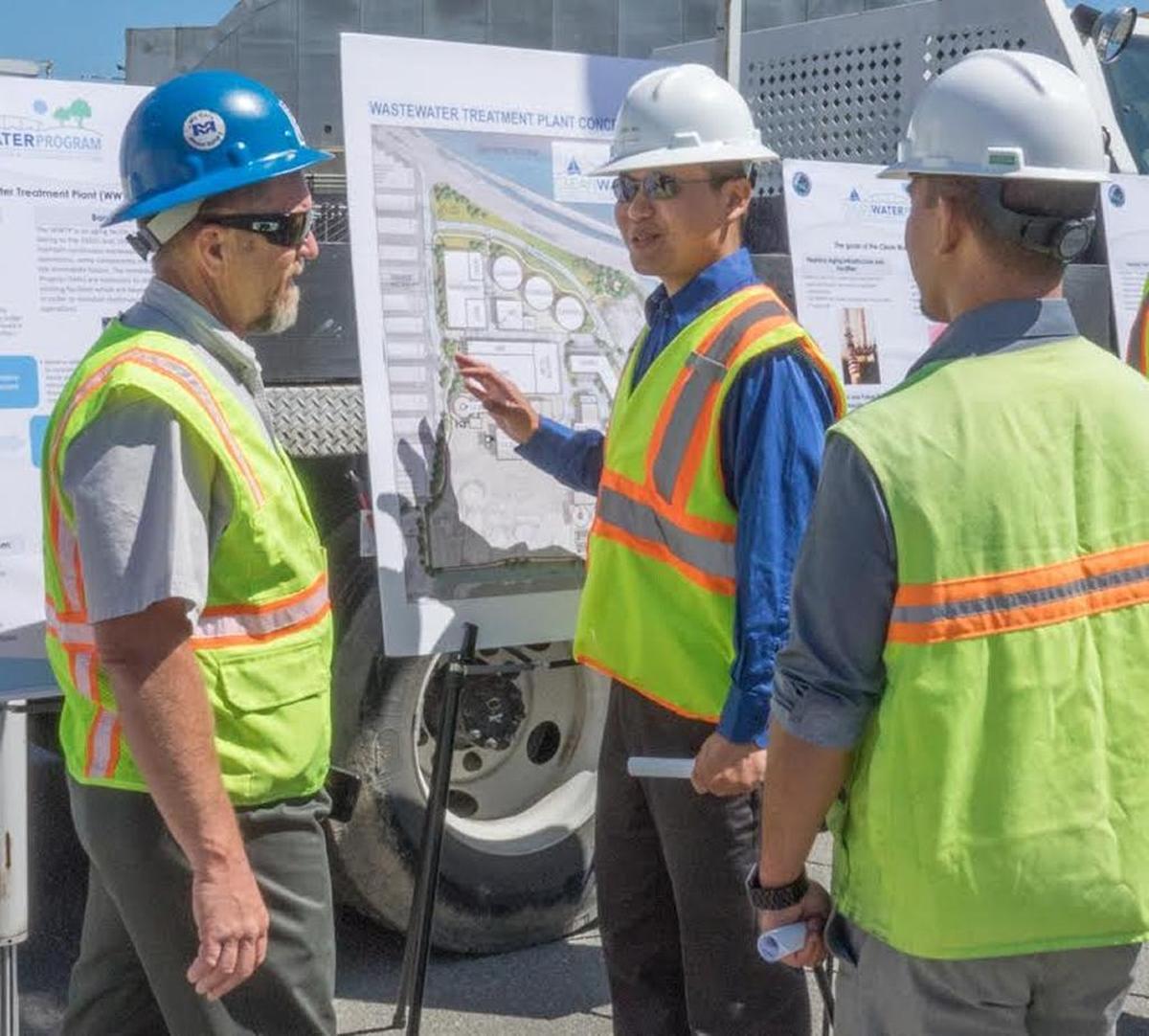 Ed Moore, left in the blue hard hat, at work on a wastewater treatment plant construction site in San Mateo.