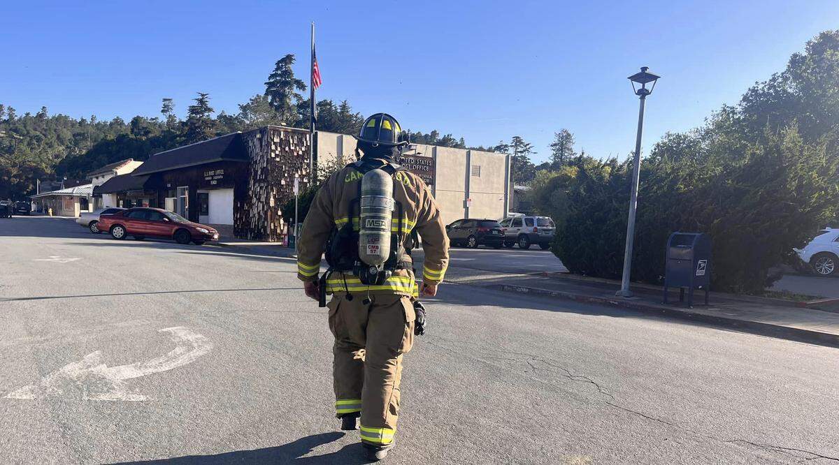 A Cambria Fire Department firefighter enforces an evacuation zone around Cambria’s Post Office on Wednesday, April 19, 2023, after a gas leak was reported.