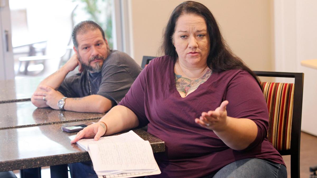 Monika Saenz runs a facebook group that helps North County people, seated behind her is her husband David. She keeps requests in a notebook and posts them on the social media site. David Middlecamp 12-23-2019