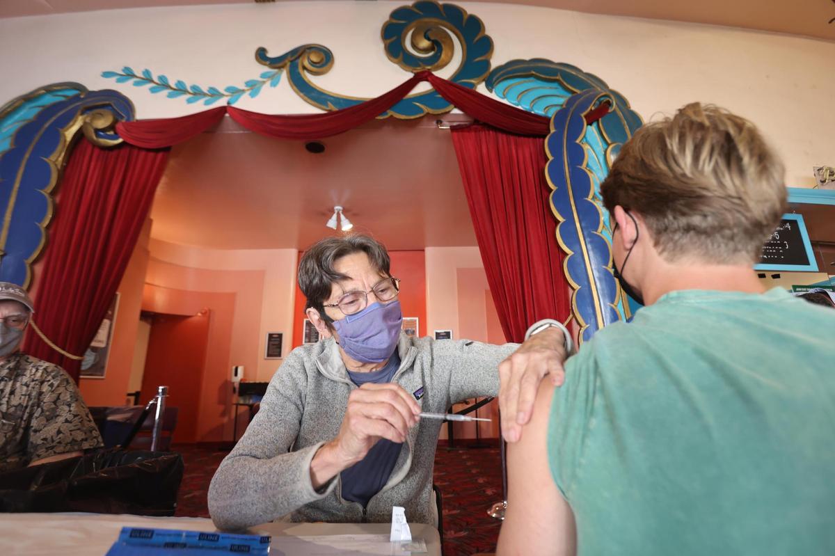 Dr. Patricia Bromberger administers a second Pfizer vaccine dose to Forrest Powell, a business administration student at Cal Poly, during a pop-up vaccine clinic at the Fremont Theater in San Luis Obispo in September. The San Luis Obispo County Public Health Department is holding mobile vaccine clinics at various locations to encourage more people to get COVID-19 shots.