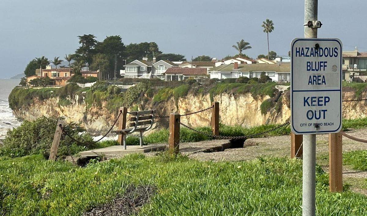 A sign in Shell Beach warns people to stay off the bluff near the bench where a widening crack is threatening to send the cliffside tumbling onto the beach below.