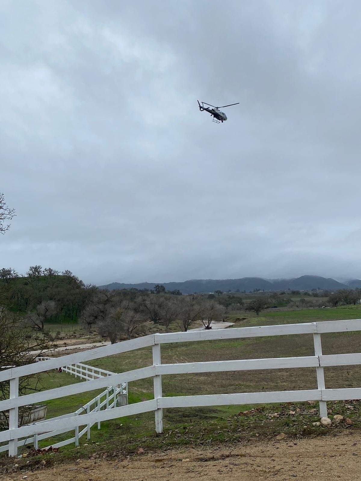 A CHP helicopter aids in the search for 5-year-old Kyle Doan on Wednesday, Jan. 11, 2023, two days after he disappeared in swollen San Marcos Creek near San Miguel.