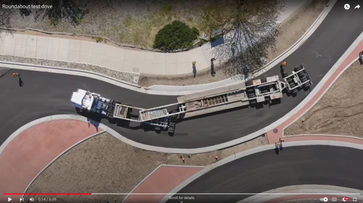 A 107-foot truck and trailer navigate the new roundabout on Golden Hill Road in Paso Robles as part of a test before it opens in June.