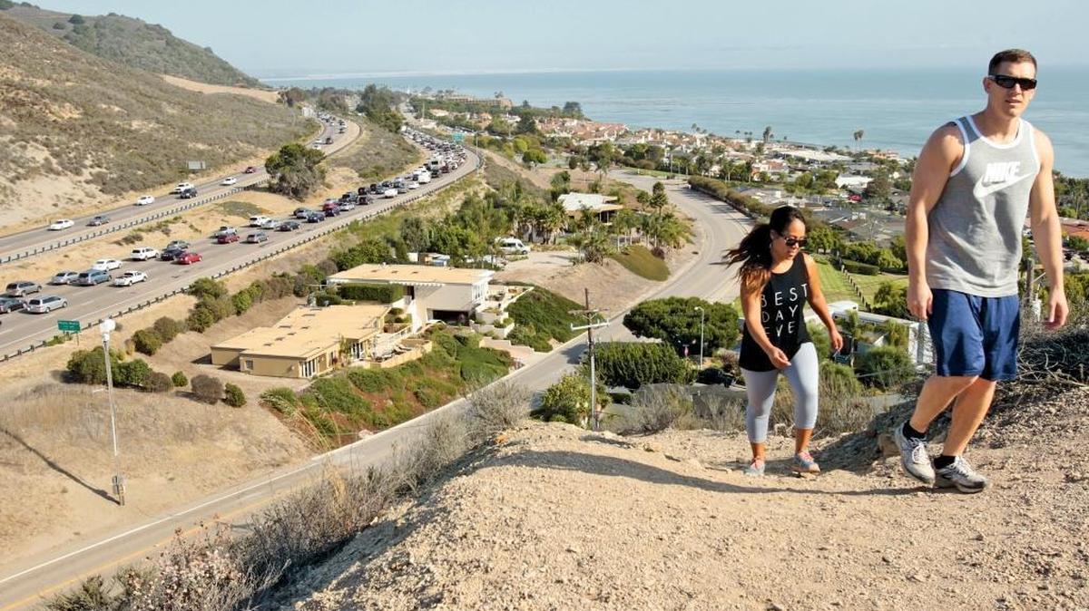 Naomi Kelly and Steve Vizzusi take a hike in Shell Beach.