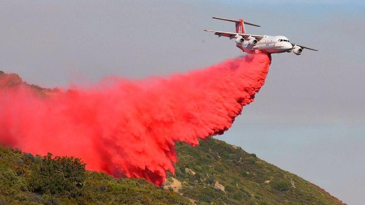 A BAe-146 airliner drops fire retardant on the Sherpa Fire on Saturday. The blaze has burned more than 7,000 acres near Goleta in Santa Barbara County.