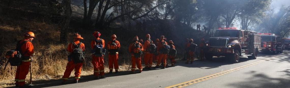 An inmate crew prepares to be assigned as firefighters fight a brush fire off Pozo Road near Santa Margarita on Monday, Oct. 9, 2017.