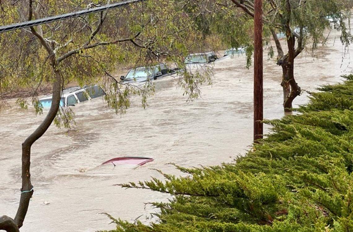 Floodwaters cover vehicles on South Bay Boulevard at Quintana Road in Morro Bay on Jan. 9, 2023.