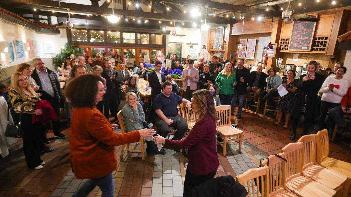 Dawn Addis hands the microphone to Erica Stewart as candidates thank supporters at Big Sky Cafe on Election Night Nov. 8, 2022.