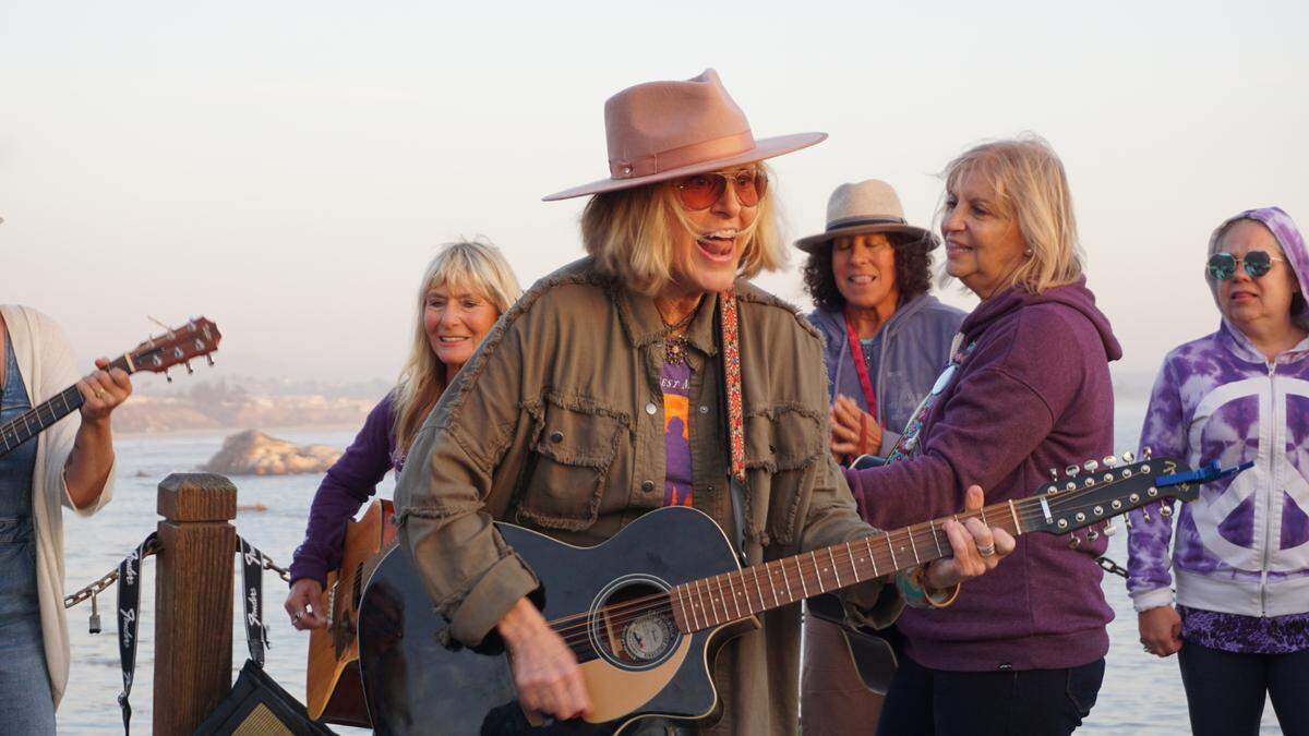 People gathered at a memorial for Kristin Smart in Shell Beach following the announcement of the verdict. Therese Cron, center, is a member of the “Jam Fam,” a musical group that plays at Smart’s memorial. 
