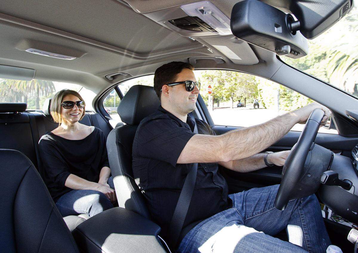 Uber driver Ryan Perron ferries passanger Megan Hannon from Cal Poly to downtown San Luis Obispo on a Friday evening in 2015.
