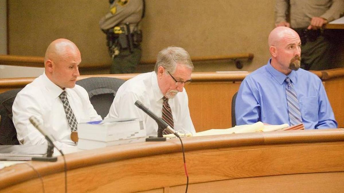 Salinas Valley State Prison guards Sergio Aranda, left, and Travis Woolf, right, listen during their preliminary hearing in November 2014. Attorney Denton Wilson is in the center.