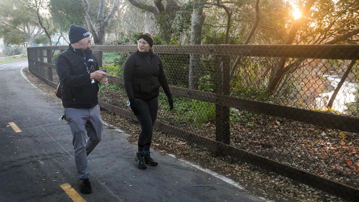 Jack Lahey and Kelsey Nocket walk along the Bob Jones Trail near Prado Road at sunrise.