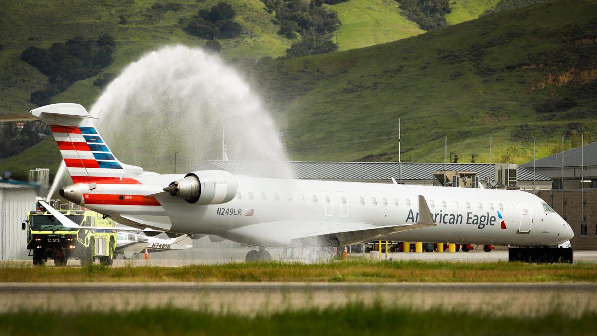 American Airlines flight 5791 from Dallas/Fort Worth International Airport is greeted with a water salute from an aircraft rescue and firefighting vehicle as it arrives in San Luis Obispo for the first time. The new connecting flight between Dallas-Fort Worth and San Luis Obispo, California, began Tuesday. The flight, offering year-round service, now is the farthest east local fliers can travel on a non-stop flight. Photo by Joe Johnston 04-02-19