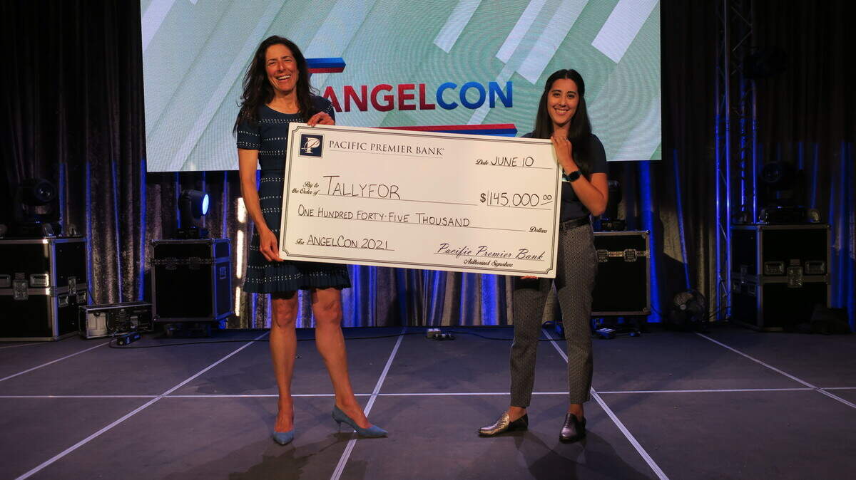 The startup pitch competition AngelCon 2022 takes place Thursday, April 21, 2022, at SLO Brew Rock. In an image from 2021, Judy Mahan, economic development director with Cal Poly’s Center for Innovation and Entrepreneurship SBDC, holds the winner’s check with Liz Fisher, program manager at Cal Poly CIE SBDC.