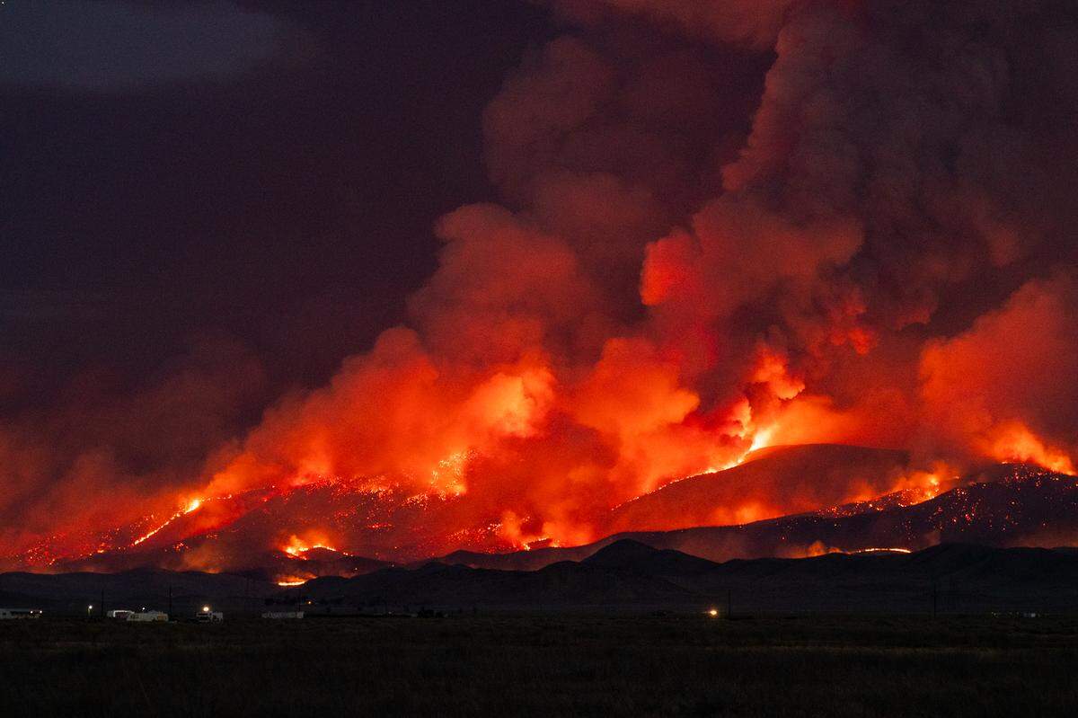 Flames from the Madre Fire burn on a hillside in eastern San Luis Obispo County on July 2, 2025.