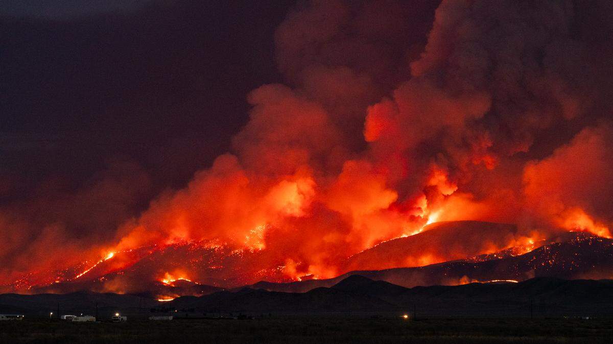 Flames from the Madre Fire burn on a hillside in eastern San Luis Obispo County on July 2, 2025.