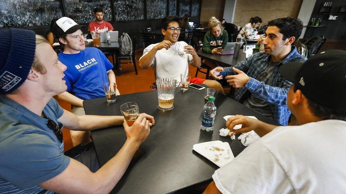 Colin Dzubnar, left, Kenny Kimbrough, Nick Nam, Alex Sargiss and Irl Barajas enjoy some afternoon beers and conversation at Cal Poly’s Mustang Station.